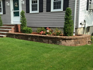 landscaping and masonry retaining wall by BJ Dinsmore Lanscaping of Billerica, MA